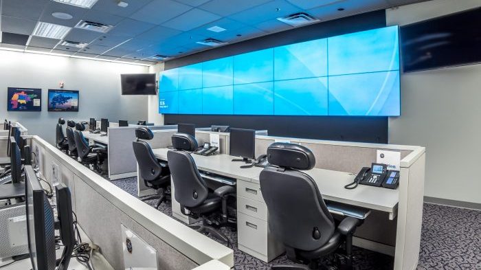 Control room with a large multi-display video wall and operator workstations